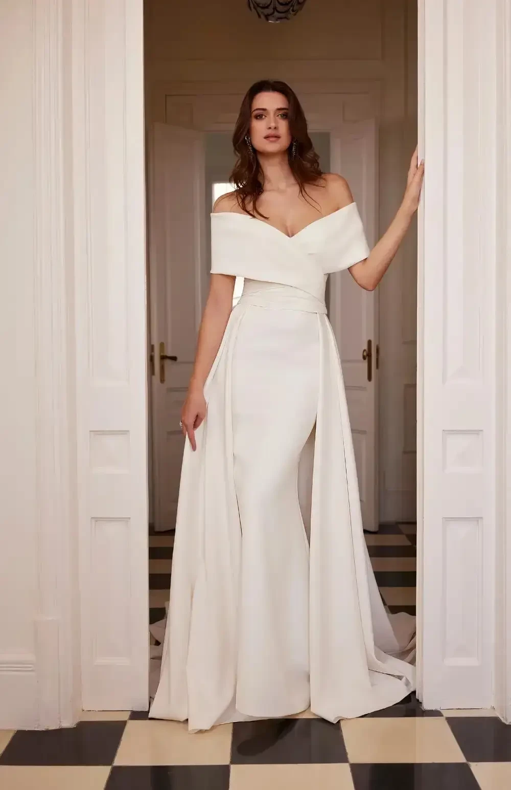 model is wearing an off the shoulder fit and flare bridal gown