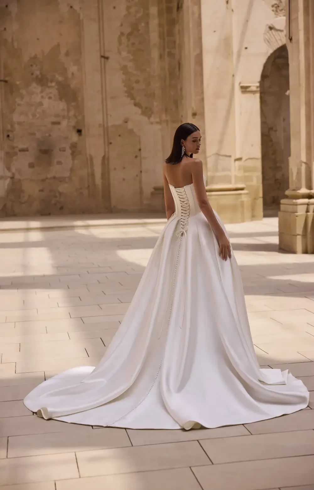 model is wearing a strapless ball gown