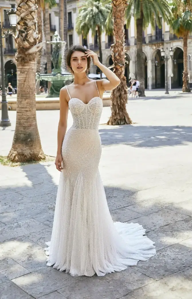 model is wearing a jersey stretch spaghetti strap wedding gown