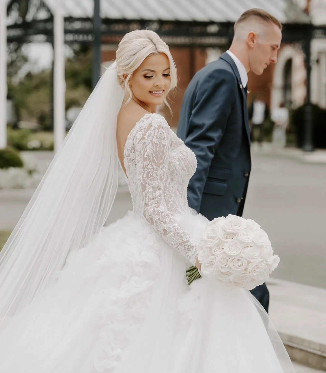Сouple wearing a white gown and a black suit