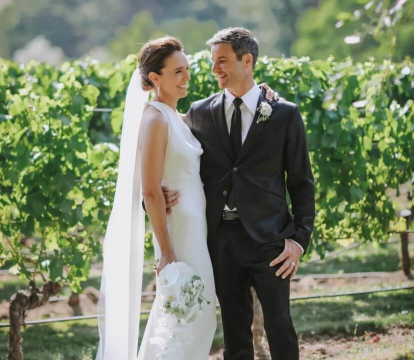 Сouple wearing a white gown and a black suit