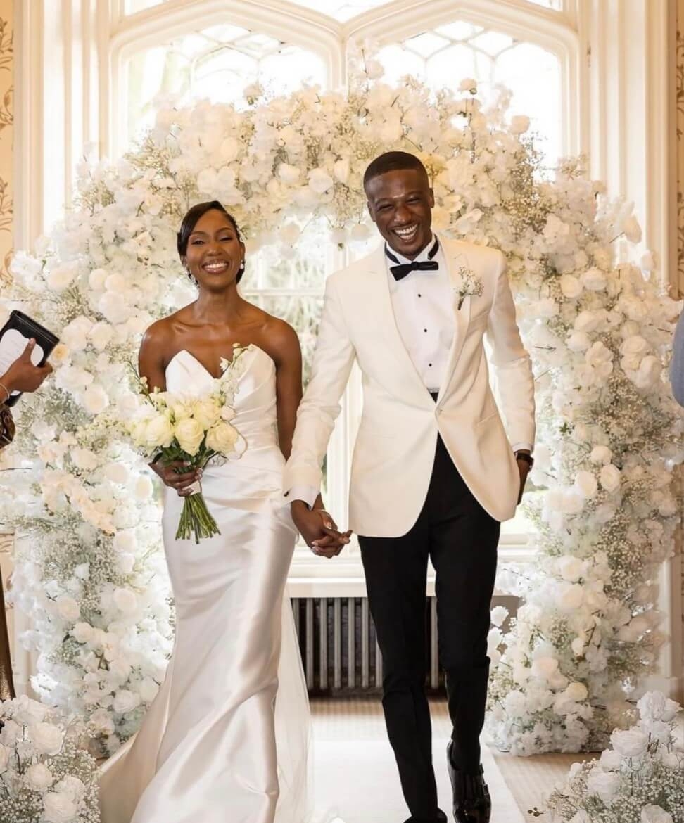 Сouple wearing a white gown and a white suit